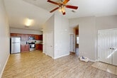Located at 14001 Three Rivers Rd in Gulfport, Mississippi, this single-story 2-bedroom, 2-bathroom home offers a comfortable and efficiently designed living space. The open-concept living and dining area immediately impresses with vaulted ceilings and a ceiling fan, creating an airy, spacious feel. Light wood-look flooring flows consistently throughout the main living areas, lending warmth and cohesion to the interior.

The kitchen is well-equipped, featuring rich wooden cabinetry, granite-look countertops, and a full suite of stainless steel appliances including a refrigerator, range, microwave, and dishwasher. It connects seamlessly to the dining area, making the space ideal for everyday living and entertaining.

Both bedrooms are generously proportioned, each with ceiling fans and ample natural light from windows fitted with blinds. The primary bedroom offers notable space, while both rooms benefit from abundant closet storage — a standout feature with seven closets throughout the home. The two bathrooms are finished with tile flooring and include shower areas. An in-unit laundry area adds further convenience. A dedicated entrance, hallway, and thoughtful layout complete this functional and comfortable home.