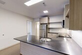 Located at 400 Langley Rd in Newton, MA, this well-appointed 2-bedroom, 2-bathroom residence offers a thoughtfully designed single-level layout with a clean, contemporary aesthetic throughout. The open-concept living area seamlessly connects the kitchen, dining, and living spaces, creating a bright and functional hub for daily life. The modern kitchen is a standout feature, boasting a large island with a dark stone countertop and integrated sink, light wood-grain cabinetry, open shelving, a white subway tile backsplash, and stainless steel appliances including a refrigerator, range, and over-the-range microwave. Warm hardwood-style flooring flows through the main living areas, while the living room benefits from generous natural light and direct access to a private outdoor deck. Both bedrooms are well-proportioned, with the primary bedroom offering a dedicated closet and easy access to its own bathroom. The bathrooms are finished with large-format tile flooring, wood-tone vanities, dark stone countertops, and mirrored medicine cabinets. Additional highlights include four closets for abundant storage and a dedicated in-unit laundry area, rounding out this practical and stylish residence.