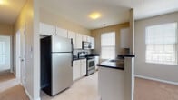 Located at 6460 Chelsea Glen Dr in Canal Winchester, Ohio, this single-floor residence offers a well-organized and functional layout suited for comfortable everyday living. The open-concept design connects the kitchen and living area seamlessly, creating a welcoming communal space. The kitchen is outfitted with white cabinetry, dark countertops, stainless steel appliances including a refrigerator, electric range, and over-the-range microwave, complemented by light tile flooring and a peninsula with an integrated sink. The living area features soft carpeting and multiple windows that invite natural light, with views of the surrounding neighborhood. The bedrooms are carpeted and generously proportioned, each offering natural light through large windows and ample closet access. One bedroom includes a private en-suite bathroom. The bathrooms feature white vanity cabinetry, dark countertops, tile flooring, and a tub/shower combination. A tiled entryway provides a clean transition into the main living spaces. Neutral wall tones and clean white trim are consistent throughout the home, creating a cohesive and understated aesthetic. The overall ambiance is bright, clean, and move-in ready.