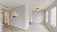 Located at 5808-A S Alameda St in Corpus Christi, Texas, this single-floor unit offers a clean, modern aesthetic throughout. The living areas feature light wood-look flooring and soft grey walls that create a bright, cohesive atmosphere. Multiple windows with blinds allow natural light to flow through the space, complemented by ceiling fans that provide comfort year-round.

The open living area is generously proportioned, with a pass-through window connecting it to the kitchen, adding a sense of openness between the spaces. The kitchen is efficiently designed with white cabinetry, a decorative tile backsplash, dark countertops, tile flooring, and built-in appliances including a range and dishwasher. A built-in shelving unit at the kitchen entrance offers convenient additional storage.

The bedrooms continue the light flooring and neutral color palette, each equipped with ceiling fans and windows that bring in natural light. The layout also includes a dedicated hallway for privacy between rooms.

Two bathrooms serve the unit — one featuring a vanity with granite-style countertops, white cabinetry, and a framed mirror, and a full bathroom with a tub-shower combination, tile flooring, and a matching vanity setup. The overall design is practical, well-maintained, and move-in ready.
