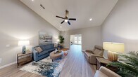 Located at 5999 Paradise Circle Rd in Saginaw, MI, this well-designed single-story home offers three bedrooms and three bathrooms across a thoughtfully laid-out floor plan. The living room impresses with soaring vaulted ceilings, recessed lighting, a ceiling fan, and light wood-tone flooring that flows throughout the home, creating a bright and airy atmosphere. A second living area features French doors that open to outdoor views of the surrounding landscape, bringing in an abundance of natural light.

The kitchen is a standout space, boasting vaulted ceilings, white upper cabinetry, rich dark lower cabinetry, light stone countertops, stainless steel appliances, and a central island with bar seating — ideal for both cooking and casual dining.

The primary bedroom is a comfortable retreat with neutral tones and easy access to a private bathroom. Additional bedrooms feature wood-tone flooring and natural light from windows with blinds. The bathrooms are finished with dark wood vanities and stone-topped counters. Closets include wire shelving systems for practical storage.

A dedicated laundry room with full-size washer and dryer hookups and wire shelving adds everyday convenience. The home's cohesive neutral palette and modern finishes provide a clean, move-in ready feel throughout.