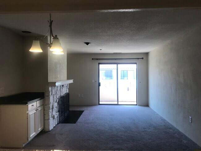 Living room with fireplace and access to patio - 1396 El Camino Real