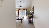 Located at 5420 Falcon Ridge Dr in Fort Worth, TX, this two-bedroom, two-bathroom single-floor home offers a well-organized layout with a comfortable and functional design throughout. The living room serves as the heart of the home, featuring vaulted ceilings, a ceiling fan, and a tile-surround wood-burning fireplace that adds warmth and character. A sliding glass door floods the space with natural light and provides access to the outdoors, framed by decorative drapery. Plush carpet runs throughout the living areas and bedrooms, contributing to a cozy ambiance. The adjoining dining area benefits from a large bay window that invites abundant sunlight, creating a bright and inviting space. The kitchen features warm wood cabinetry, granite-look countertops, tile flooring, and a breakfast bar that opens to the main living area. The primary bedroom offers a comfortable retreat with carpeted flooring and vaulted ceilings. The second bedroom provides versatile space with mirrored closet doors. Both bathrooms are fitted with tile flooring, wood vanity cabinetry, and tub-shower combinations. A connecting hallway ties the layout together, ensuring easy navigation throughout this efficiently designed home.