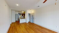 Located at 1109 Matteo Dr in Wilmington, NC, this single-story residence offers a thoughtfully designed layout with a clean, modern aesthetic throughout. The open-concept living area features warm hardwood flooring, crisp white walls, and ceiling fans that enhance both comfort and airflow. Natural light filters in through glass-paneled exterior doors, creating a bright and welcoming atmosphere.

The kitchen is a standout feature, showcasing rich dark wood cabinetry, granite countertops, and a full suite of stainless steel appliances including a refrigerator, electric range, and built-in microwave. Pendant lighting above the breakfast bar adds a contemporary touch, while an adjacent pantry provides ample storage space.

The bedrooms are carpeted for comfort, each offering ceiling fans and generous closet space, including a walk-in closet in the primary bedroom. The primary bedroom also connects to an en-suite bathroom equipped with a granite-topped vanity, dark wood cabinetry, and a tub-shower combination with tile flooring. A second full bathroom mirrors the same refined finishes, featuring a large mirror, granite countertop, and tile floors.

An exterior door opens to a covered entry area, offering a convenient transitional space. The overall design balances practicality with modern finishes, making this a well-appointed residence in Wilmington.