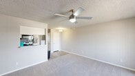 Located at 1500 East Broadway Road in Tempe, Arizona, this single-story, one-bedroom, two-bathroom home offers a practical and comfortable layout. The open-concept living and dining area forms the heart of the home, finished with plush carpeting and a ceiling fan with integrated lighting. A textured ceiling adds character throughout the main living space. The kitchen connects seamlessly via a pass-through counter, showcasing white cabinetry, subway tile backsplash, stainless steel appliances including a refrigerator, and a pantry for additional storage. Wood-look vinyl flooring runs through the kitchen and hallway areas, creating a clean contrast to the carpeted rooms. The spacious bedroom is well-appointed with a ceiling fan, a window with natural light, and a sliding closet. Four closets in total are distributed throughout the home, offering excellent storage capacity. The two bathrooms are clean and functional, one featuring a full tub-shower combination with chrome fixtures. The hallway connects the private areas of the home with ease. Neutral tones, textured walls, and consistent finishes give the entire space a cohesive, move-in-ready feel suited for comfortable everyday living in the heart of Tempe.