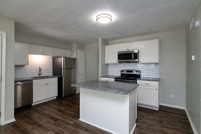 Granite counter tops and plenty of cabinet space. - Fort West Apartments