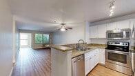 Located at 650 Front St, Unit 301 in downtown San Diego, this well-appointed two-bedroom, two-bathroom residence offers a functional and comfortable layout across a single floor. Wood-look flooring runs consistently throughout the unit, lending a cohesive and clean aesthetic to every room.

The open-concept living and kitchen area serves as the heart of the home. The kitchen features a peninsula with granite countertops, white cabinetry, stainless steel appliances including a refrigerator and microwave, and track lighting overhead. A ceiling fan with a light fixture anchors the living area, which receives natural light through a window fitted with vertical blinds and offers access to an outdoor area via a glass door.

Both bedrooms are comfortably sized with neutral walls, wood-look flooring, and ample natural light. The primary bedroom includes a mirrored sliding closet door, adding a sense of depth to the space. Each bedroom is served by its own dedicated closet for organized storage.

The two full bathrooms are identically appointed, each featuring a sliding glass shower/tub enclosure, a white vanity with granite countertops, and wood-look flooring. The clean, bright finishes throughout both bathrooms contribute to the unit's consistent, modern aesthetic. This residence offers a practical and polished living environment in a prime San Diego location.