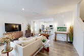 Located at 216 Meyers Ridge Rd in Cramerton, NC, this two-story home offers a thoughtfully designed floor plan across two well-proportioned levels. The main floor features an open-concept living, dining, and kitchen area bathed in natural light, with durable wood-look flooring throughout. The kitchen is a standout, boasting crisp white shaker cabinetry, granite countertops, a central island with a sink, stainless steel appliances, and recessed lighting. The living area flows seamlessly into the dining space, creating an inviting atmosphere ideal for everyday living and entertaining. A patio provides outdoor access from the main level. Upstairs, three carpeted bedrooms offer comfortable retreats, including a generously sized primary bedroom with its own dedicated closet space. Additional bedrooms are bright and versatile, with large windows framing outdoor views — one functioning well as a home office. Seven closets throughout the home ensure exceptional storage. Three full bathrooms feature tile flooring, vanities with ample cabinetry, and tub-shower combinations. Two staircases and hallways connect both floors efficiently. The home's clean, modern aesthetic and functional layout make it a practical and attractive residence in the Cramerton community.