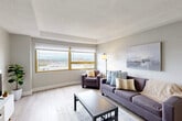 Located at 400 Maynard Street in the heart of Ann Arbor, Michigan, this one-bedroom, one-bathroom unit offers a well-organized single-floor layout designed to maximize every square foot. The living room serves as the centerpiece of the space, featuring light wood-style flooring, neutral gray walls, and a textured ceiling. Large gold-framed windows allow generous natural light to pour in while offering elevated views of the Ann Arbor skyline — a standout feature of the unit. The living and dining areas flow together seamlessly, creating an open and functional everyday living environment.

The galley-style kitchen is efficiently laid out with warm wood cabinetry, dark granite countertops, a stainless steel range, and a refrigerator, all set atop classic tile flooring. The bathroom mirrors the kitchen's design aesthetic, featuring a dark granite vanity top, wood cabinetry, and a tub with shower. The bedroom is a comfortable, well-proportioned room with the same light flooring found throughout, a reach-in closet, and a window with city views. Connecting hallways provide practical transitions between spaces. Overall, the unit presents a clean, modern aesthetic with consistent finishes throughout.