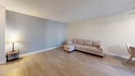 Located at 4341 Spring St in La Mesa, CA, this single-floor, one-bedroom, two-bathroom unit offers a practical and well-appointed layout. The open-concept living and dining area is finished with light wood-style flooring throughout, textured ceilings, and neutral-toned walls, creating a bright and clean aesthetic. A ceiling fan enhances comfort in the living space, which flows naturally into the dining area with access to natural light via vertical blinds. The kitchen features white cabinetry, light countertops, and stainless steel appliances including a refrigerator, electric range, and built-in range hood, offering a functional cooking environment. The bedroom is a comfortable, well-proportioned room with a window overlooking greenery, providing natural light and outdoor views. The primary bathroom includes a white vanity with a quartz-style countertop, framed mirror, and opens directly to the bedroom. A second full bathroom features a shower/tub combination and full-length mirror. A dedicated closet provides additional storage. The unit's consistent flooring, neutral color palette, and clean finishes create a cohesive and move-in ready living environment.