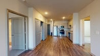 Located in Douglasville, GA, this single-floor unit offers a clean, modern design throughout. The open-concept layout connects the main living area to a well-appointed kitchen, which features light wood-tone cabinetry, granite-style countertops, a full suite of stainless steel appliances including a refrigerator, electric range, microwave, and dishwasher, and durable wood-style plank flooring that extends through the main living spaces. Recessed lighting illuminates the kitchen and common areas, creating a bright and welcoming atmosphere. Multiple bedrooms are finished with soft wall-to-wall carpeting, ceiling fans, and windows with blinds that allow for natural light. The unit includes multiple bathrooms, one featuring a single-sink vanity with wood-tone cabinetry and a walk-in shower area, while another offers a bathtub-shower combination alongside a vanity and access to a walk-in closet with built-in shelving. Neutral wall tones and clean finishes throughout contribute to a cohesive and contemporary aesthetic. The layout, as visible from the dollhouse view, offers a functional and spacious floor plan well-suited for everyday living.