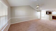 Located at 700 Greenlawn Dr in Columbia, SC, this single-floor residence offers a thoughtfully designed layout across two bedrooms and two bathrooms. The open-concept living area is a standout feature, boasting soaring vaulted ceilings with a ceiling fan, neutral-toned carpet, and windows with blinds that invite natural light. A half-wall with decorative columns visually connects the living room to the kitchen, enhancing the sense of openness.

The kitchen is well-equipped with rich dark wood cabinetry, granite countertops, stainless steel appliances including an electric range and dishwasher, and light hardwood-style flooring. A peninsula counter provides additional workspace and a natural transition into the living area.

Both bedrooms are carpeted and feature windows with blinds, offering natural light and a calm atmosphere. The generously sized primary bedroom benefits from its own vaulted ceiling and ceiling fan. The two bathrooms feature light hardwood-style flooring, dark wood vanities with light countertops, and full tub-shower combinations. An outdoor deck with wood plank flooring rounds out this comfortable and functional residence.