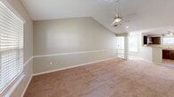 Located at 700 Greenlawn Dr in Columbia, SC, this single-floor residence offers a thoughtfully designed layout across two bedrooms and two bathrooms. The open-concept living area is a standout feature, boasting soaring vaulted ceilings with a ceiling fan, neutral-toned carpet, and windows with blinds that invite natural light. A half-wall with decorative columns visually connects the living room to the kitchen, enhancing the sense of openness.

The kitchen is well-equipped with rich dark wood cabinetry, granite countertops, stainless steel appliances including an electric range and dishwasher, and light hardwood-style flooring. A peninsula counter provides additional workspace and a natural transition into the living area.

Both bedrooms are carpeted and feature windows with blinds, offering natural light and a calm atmosphere. The generously sized primary bedroom benefits from its own vaulted ceiling and ceiling fan. The two bathrooms feature light hardwood-style flooring, dark wood vanities with light countertops, and full tub-shower combinations. An outdoor deck with wood plank flooring rounds out this comfortable and functional residence.