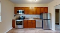 This 2-bedroom, 1-bathroom unit at 350 Baldwin Rd in Parsippany, NJ offers a clean, functional layout across a single floor. The interior features light-toned laminate hardwood flooring throughout, contributing to a bright and cohesive aesthetic in every room.

The kitchen is a standout space, outfitted with rich warm-toned cabinetry, granite countertops, a subway tile backsplash, and a full suite of stainless steel appliances including a range, microwave, dishwasher, and refrigerator. Track lighting overhead adds a practical finishing touch.

Both bedrooms are well-proportioned and filled with natural light from multiple windows fitted with blinds. One bedroom features baseboard heating and a wall-mounted air conditioning unit for year-round comfort, while the other offers a spacious closet for ample storage. The neutral wall tones create a versatile backdrop throughout.

The bathroom is neatly appointed with tile flooring, a wood-accented vanity, and a full tub-shower combination with tile surround and a window that allows in natural light.

The overall layout, as seen from the dollhouse view, is efficient and well-connected, making the space comfortable and easy to navigate. Baseboard heating is present throughout, ensuring consistent warmth during cooler months.