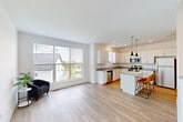 Located at 2501 Avant Ave in Ann Arbor, MI, this modern three-bedroom, four-bathroom home is thoughtfully laid out across three floors. The entry-level floor offers a versatile living space with light hardwood-style flooring, recessed lighting, and sliding glass doors that open to a green outdoor area, filling the room with natural light and providing easy outdoor access.

The main living floor features an open-concept kitchen and living area, where clean white cabinetry, granite countertops, and stainless steel appliances—including a dishwasher, microwave, and range—define a well-appointed kitchen. A central island with seating complements the space, while a large picture window frames neighborhood views and brings in abundant daylight. The living area flows naturally from the kitchen, creating an ideal layout for entertaining.

Each of the four bathrooms features a white vanity with granite countertops and a well-lit mirror. The three bedrooms are carpeted and bright, with generous windows overlooking the surrounding area. Two closets, including a walk-in, provide ample storage. The dedicated laundry room houses a full-size side-by-side washer and dryer. With a crisp, contemporary design throughout, this home offers a clean, functional living environment.