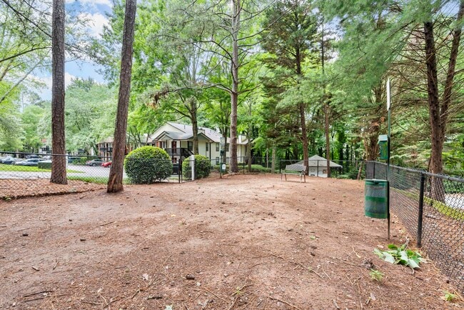 Let your pup run free in our spacious dog park. - The Addison at Sandy Springs