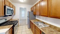 Located at 3131 Meetinghouse Rd in Boothwyn, PA, this two-story home offers three bedrooms and four bathrooms across two well-proportioned floors. The main level features a bright, carpeted living area with multiple windows and a sliding glass door that opens to the outdoors, filling the space with natural light and providing easy access to the exterior. The kitchen and dining area are combined into a functional layout, finished with light tile flooring, warm honey-toned cabinetry, granite-style countertops, stainless steel appliances including a gas range, dishwasher, and refrigerator, plus a double-basin sink. Upstairs, the three bedrooms are finished with plush carpeting and feature natural light from individual windows. The generously sized primary bedroom includes closet space, while additional bedrooms offer built-in closets with organizing systems. A carpeted hallway with wall sconce lighting connects the upper-level rooms. The four bathrooms are clean and functional, each featuring tiled tub-shower combinations with chrome fixtures. Throughout the home, neutral wall tones and consistent finishes create a cohesive and move-in-ready aesthetic suited for comfortable everyday living.
