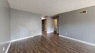 Located at 1945 Everetts Folly St in Memphis, TN, this 2-bedroom, 1-bathroom residence offers a practical and comfortable single-floor layout. The living room is a standout feature, boasting dark wood-style flooring, a fireplace, and a large sliding glass door with vertical blinds that floods the space with natural light. Adjacent to the living area, the kitchen is designed with a pass-through opening that maintains visual connectivity. It is equipped with white cabinetry, laminate countertops, a double basin sink, a dishwasher, and a range, alongside a window that brings in additional natural light. Both bedrooms are carpeted and painted in neutral gray tones. The primary bedroom is generously sized, featuring two closets and hardwood-style flooring leading into the room, while the secondary bedroom includes its own closet and a window with an outdoor view. The shared bathroom offers a dual-sink vanity with a large mirror and laminate countertop, providing ample space. Throughout the residence, textured ceilings, white trim, and a consistent gray color palette create a cohesive and clean aesthetic.