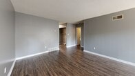 Located at 1945 Everetts Folly St in Memphis, TN, this 2-bedroom, 1-bathroom residence offers a practical and comfortable single-floor layout. The living room is a standout feature, boasting dark wood-style flooring, a fireplace, and a large sliding glass door with vertical blinds that floods the space with natural light. Adjacent to the living area, the kitchen is designed with a pass-through opening that maintains visual connectivity. It is equipped with white cabinetry, laminate countertops, a double basin sink, a dishwasher, and a range, alongside a window that brings in additional natural light. Both bedrooms are carpeted and painted in neutral gray tones. The primary bedroom is generously sized, featuring two closets and hardwood-style flooring leading into the room, while the secondary bedroom includes its own closet and a window with an outdoor view. The shared bathroom offers a dual-sink vanity with a large mirror and laminate countertop, providing ample space. Throughout the residence, textured ceilings, white trim, and a consistent gray color palette create a cohesive and clean aesthetic.