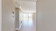 Located at 1617 Fannin St in Houston's vibrant Midtown district, this one-bedroom, one-bathroom unit offers a well-organized, single-floor layout designed for efficient urban living. Light wood-tone flooring runs throughout, lending warmth and continuity across all rooms.

The spacious living room is a standout feature, anchored by a large sliding glass door that opens onto a private balcony. Floor-to-ceiling vertical blinds frame sweeping views of the Houston skyline, filling the room with abundant natural light. Crown molding and a textured ceiling add classic architectural detail to the space.

The kitchen is well-appointed with white shaker-style cabinetry, dark granite countertops, a white subway tile backsplash, a double stainless steel sink, and stainless steel appliances including a range and dishwasher.

The bedroom is a comfortable, well-proportioned retreat with its own access to the balcony through a sliding glass door, continuing the city views. Two closets provide ample storage, complemented by additional hallway storage throughout the unit.

The bathroom features a clean, bright design with a white vanity, mirror with overhead lighting, tiled flooring, and a tub-shower combination. The overall palette of warm neutrals creates a cohesive and inviting atmosphere throughout.