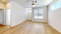 Located at 102 Francis Rd in Hendersonville, NC, this two-story home offers a well-designed layout spread across two floors. The main level hosts the open-concept kitchen and living room, both finished with light hardwood-style flooring that lends a clean, modern feel. The kitchen is a standout, featuring crisp white shaker cabinetry, dark granite countertops, a subway tile backsplash, a central island with built-in shelving, and a full suite of stainless steel appliances including a refrigerator, range, microwave, and dishwasher. Natural light flows in through multiple windows fitted with blinds. The living room is bright and airy, accented by a ceiling fan and direct access to the exterior. Upstairs, three bedrooms provide comfortable retreats — the primary bedroom is generously sized and includes an en-suite bathroom and walk-in closet with wire shelving. Bedrooms are carpeted for warmth and comfort, each featuring ceiling fans and natural light from well-placed windows. The bathrooms are finished with granite-topped white vanities and hardwood-style flooring; one features a tub-shower combination. Three closets throughout the home offer ample storage. The home's neutral palette and modern finishes create a cohesive, move-in-ready atmosphere throughout.