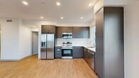 This thoughtfully designed 2-bedroom, 2-bathroom residence in Fontana, California offers a clean, contemporary aesthetic throughout its single-floor layout. Light wood-style flooring flows seamlessly across all areas, complementing the bright white walls and recessed lighting that create an airy, well-lit atmosphere.

The open-concept kitchen and living area serves as the heart of the home, featuring sleek dark charcoal cabinetry with modern hardware, a white tile backsplash, and a full suite of stainless steel appliances including a french-door refrigerator with ice maker, electric range, over-the-range microwave, and dishwasher. Ample upper and lower cabinet storage, along with a tall pantry column, provide generous kitchen utility. Windows draw in natural light and frame views of the surrounding neighborhood.

Both bedrooms are well-proportioned, bright, and tranquil, with large windows that fill each room with natural light. The primary bedroom is a comfortable retreat with dedicated closet space. Two full bathrooms feature wood-look flooring, dark vanity cabinetry, and shower-tub combinations with built-in shelving.

Additional highlights include a dedicated laundry area, five closets for abundant storage, two hallways, and a private balcony. The residence presents a modern, move-in-ready environment with a cohesive and functional design throughout.