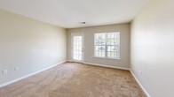 Located at 104 Sharon Ct in Blaine, Tennessee, this two-bedroom, two-bathroom single-story residence offers a practical and well-organized layout. The living room serves as the central gathering space, featuring neutral-toned carpet, a ceiling fan with integrated lighting, and windows that allow natural light to filter in alongside a glass-paneled exterior door providing outdoor access.

The kitchen is equipped with dark espresso cabinetry, ample upper and lower storage including a tall pantry cabinet, white countertops, and a black electric range with an overhead ventilation hood. Tile flooring completes the functional cooking space.

Both bedrooms feature warm beige carpet and neutral wall tones. The primary bedroom includes a double-door closet and a ceiling light fixture, while the second bedroom benefits from a large window with outdoor views, bringing in generous natural light.

The two bathrooms are finished with earth-toned tile flooring and dark vanity cabinetry with light countertops. One bathroom features a tub-shower combination with decorative tile accent banding, while the other offers a more open layout with a walk-in shower area. Both include mirrored vanities and ample storage.