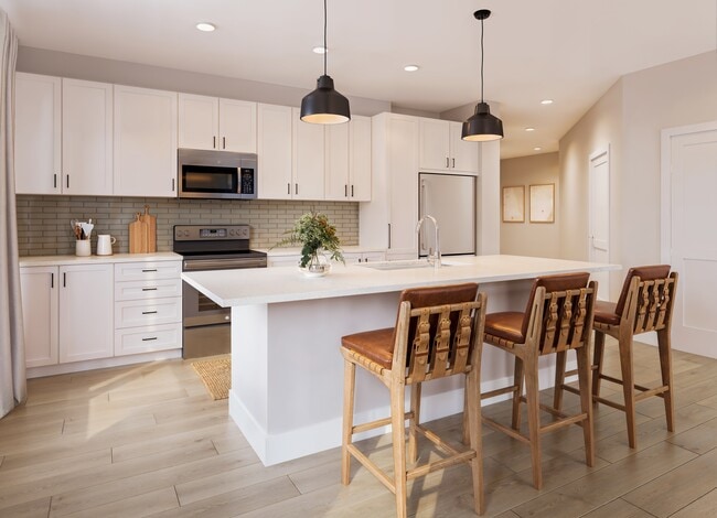 Kitchen with white cabinetry, tile backsplash, stainless steel appliances, pendant lighting, and hard-surface vinyl plank flooring (Rendering) - Avalon Lake Norman