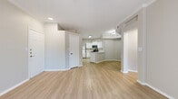 Located in Lewisville, TX, this well-appointed one-bedroom, one-bathroom residence offers a thoughtfully designed single-floor layout. Light wood-style flooring runs throughout, creating a cohesive and bright atmosphere. The open-concept living area features crown molding, recessed lighting, and a ceiling fan, with a sliding glass door that invites natural light and provides outdoor access. A hallway connects the main living space to the private areas of the home.

The kitchen is a standout feature, showcasing white shaker-style cabinetry, a light-toned countertop peninsula with an integrated sink and matte black fixtures, a subway tile backsplash, and a full suite of stainless steel appliances including a refrigerator, range, microwave, and dishwasher. Adjacent doorways provide access to a dedicated laundry area and additional storage.

The spacious bedroom includes crown molding, a ceiling fan, and a window with exterior views, creating a comfortable and well-lit retreat with its own closet. The bathroom is clean and functional, featuring a full soaking tub and shower combination with white tile surround and matte black hardware accents. The overall aesthetic is modern and neutral, offering a move-in ready environment.