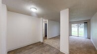 Located in North Portland, this one-bedroom, one-bathroom unit offers a practical and comfortable single-floor layout. The combined living and dining area is a highlight of the space, featuring plush carpeting, a textured ceiling, and a sliding glass door that floods the room with natural light and opens to a view of lush greenery — ideal for relaxing or entertaining. A structural column adds a subtle architectural detail to the open-concept area, while wood-style flooring defines the transition into the kitchen and hallway zones.

The kitchen is efficiently laid out and connects seamlessly to the main living area, complemented by a nearby hallway that provides access to the bedroom and bathroom. The bedroom is generously sized with soft carpeting, a window overlooking the outdoors, a baseboard heater, and two closets offering ample storage. The bathroom features wood-style flooring, a clean white tub/shower combo, and a bright, functional design. Three closets throughout the unit provide additional storage flexibility. The overall aesthetic is clean, neutral, and move-in ready.