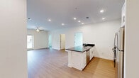 Located at 6801 W Friendly Ave in Greensboro, NC, this well-appointed residence offers three bedrooms and two full bathrooms across a thoughtfully designed single-level floor plan. The open-concept kitchen and living area serves as the heart of the home, where light hardwood-style flooring flows seamlessly underfoot. The kitchen is equipped with stainless steel appliances, crisp white shaker cabinetry, recessed lighting, and a peninsula island topped with rich dark granite countertops — a standout feature that also carries into both bathrooms. The spacious living room benefits from natural light streaming through French doors, a ceiling fan, and a clean, neutral palette that enhances the airy feel of the space. Each bedroom is finished with plush carpet and ceiling fans, offering a comfortable retreat. The bedrooms feature ample closet space, including a dedicated walk-in closet with wire shelving for organized storage. Both bathrooms are finished consistently with white vanity cabinetry, dark granite countertops, and full tub-shower combinations with curved curtain rods. The clean, modern aesthetic and neutral tones throughout create a bright, move-in-ready environment suitable for a variety of lifestyles.
