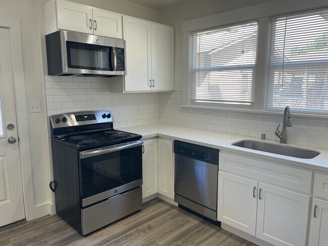 Spacious kitchen includes new cabinets and quartz countertops - 2033 S 8th St
