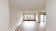 Located at 330 S New Prospect Rd in Jackson, NJ, this single-floor, 2-bedroom, 2-bathroom residence offers a practical and comfortable layout. The open living room features light hardwood-style flooring, neutral beige walls, and a textured ceiling, creating a bright and welcoming atmosphere. A tiled entryway with a closet leads seamlessly into the living space. The kitchen is equipped with rich cherry wood cabinetry, stainless steel appliances including a dishwasher, range, and microwave, complemented by tile flooring and ample counter space. Both bedrooms are carpeted and finished with neutral tones. The spacious primary bedroom features dual closets and a window that lets in natural light, while the second bedroom includes its own closet. Each bathroom is cleanly appointed — one features a tub/shower combination with white tile surround, and the second offers a vanity with white cabinetry and tile flooring. A standout feature is the dedicated laundry area with a stacked washer and dryer unit, brightened by a large window with outdoor views. Baseboard heating is present throughout. The overall design is clean, functional, and move-in ready.