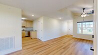 Located at 6 Parker Mathusa Place in Delmar, NY, this well-appointed single-floor home offers a thoughtfully designed layout across a comfortable and efficient footprint. The open-concept living area features vaulted ceilings with a ceiling fan and warm hardwood-style flooring that flows throughout the main spaces, creating a bright and airy atmosphere enhanced by natural light from multiple windows.

The kitchen is a standout feature, showcasing light maple cabinetry, granite countertops, and a full suite of stainless steel appliances including a range, over-the-range microwave, and dishwasher — all set over light hardwood flooring that ties the space together seamlessly.

A second living area provides additional flexibility and is accented by an elegant chandelier and a large window with outdoor views. The generous bedroom is carpeted for comfort and includes a ceiling fan, a closet, and its own window overlooking the surroundings. The bathroom is clean and functional, featuring tile flooring, a pedestal sink, and a mirror with vanity lighting.

A welcoming entry foyer with hardwood-style floors and a sidelight window adds a polished first impression. The home also includes an attached garage with an automatic opener, offering convenient and secure parking. Soft, neutral tones throughout lend the entire space a calm, move-in-ready feel.