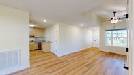 Located at 6 Parker Mathusa Place in Delmar, NY, this well-appointed single-floor home offers a thoughtfully designed layout across a comfortable and efficient footprint. The open-concept living area features vaulted ceilings with a ceiling fan and warm hardwood-style flooring that flows throughout the main spaces, creating a bright and airy atmosphere enhanced by natural light from multiple windows.

The kitchen is a standout feature, showcasing light maple cabinetry, granite countertops, and a full suite of stainless steel appliances including a range, over-the-range microwave, and dishwasher — all set over light hardwood flooring that ties the space together seamlessly.

A second living area provides additional flexibility and is accented by an elegant chandelier and a large window with outdoor views. The generous bedroom is carpeted for comfort and includes a ceiling fan, a closet, and its own window overlooking the surroundings. The bathroom is clean and functional, featuring tile flooring, a pedestal sink, and a mirror with vanity lighting.

A welcoming entry foyer with hardwood-style floors and a sidelight window adds a polished first impression. The home also includes an attached garage with an automatic opener, offering convenient and secure parking. Soft, neutral tones throughout lend the entire space a calm, move-in-ready feel.