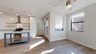 Located at 1211 East 7th Street in Tulsa, Oklahoma, this single-floor residence offers a thoughtfully designed open-concept layout filled with natural light and modern finishes. Wide-plank wood-look flooring runs throughout the living areas, complemented by neutral walls and ceiling fans that enhance the airy, comfortable atmosphere.

The kitchen is a standout feature, showcasing shiplap accent walls, white cabinetry extending to the ceiling, granite countertops, and a suite of stainless steel appliances including a side-by-side refrigerator with ice maker, electric range, and built-in microwave. A centrally positioned island with a granite top and open lower shelf adds both function and style, while glass pendant lights overhead provide warm task lighting. Open natural wood shelving adds a modern farmhouse touch.

The living and dining areas flow seamlessly from the kitchen, with multiple windows framing views of the surrounding neighborhood and allowing generous sunlight to fill the space throughout the day.

The bathrooms are finished with classic white subway tile, hexagonal mosaic tile flooring, and granite-topped vanities. One bathroom features a walk-in glass-enclosed shower, while another offers a full tub-shower combination — both clean and bright in design.

The bedroom is well-proportioned, featuring built-in cabinetry, ceiling fan, and windows with exterior views. A spacious walk-in closet completes the private quarters of this well-appointed Tulsa residence.