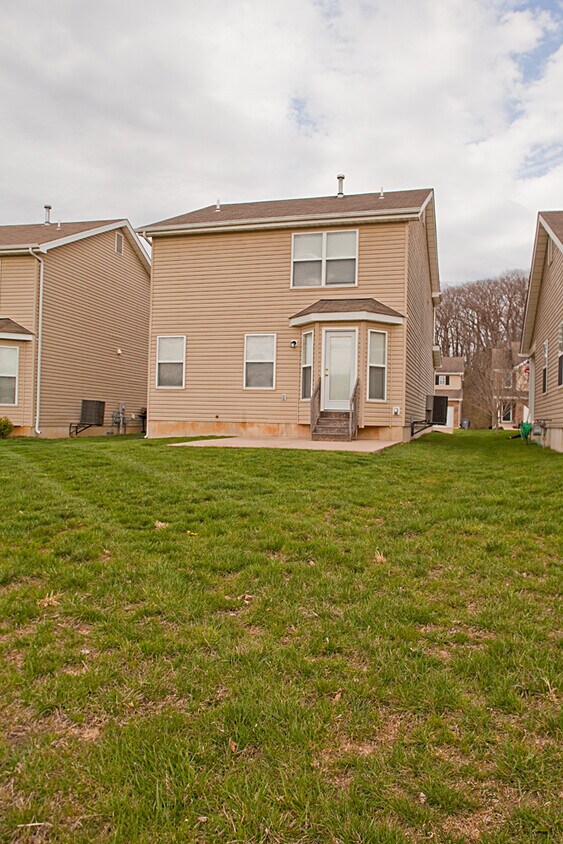 Large backyard with concrete patio perfect for entertaining. - 309 Burning Brook Dr