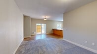Located at 1605 Oak St SE in Albany, Oregon, this single-floor, 2-bedroom, 2-bathroom home offers a well-designed, functional layout across a comfortable footprint. The open-concept kitchen and living area serves as the heart of the home, featuring warm hardwood-style flooring, a granite countertop peninsula, light maple cabinetry, and a full suite of stainless steel appliances including a range, microwave, dishwasher, and refrigerator. A window above the kitchen sink brings in natural light, while a sliding glass door in the living area opens to an outdoor patio, further brightening the space. The living room blends hardwood-style and carpeted flooring, creating distinct zones within the open layout. Both bedrooms are carpeted and well-lit, with windows offering views of surrounding greenery. The primary bedroom includes a closet and ample space. The two bathrooms feature tile flooring and chrome fixtures, with one bathroom offering a walk-in shower stall. Additional highlights include four closets throughout, a dedicated laundry area, and a connecting hallway. Neutral wall tones and clean finishes give the home a move-in ready, understated aesthetic throughout.