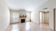 Located at 10751 Meadowglen Ln in Houston, TX, this single-story, 2-bedroom, 4-bathroom home offers a well-organized and functional layout. The living room serves as the heart of the home, featuring light hardwood-style flooring, large windows that invite natural light, and a standout stone-surround fireplace with a warm wood mantle — an elegant focal point for the space.

The galley-style kitchen is efficiently designed with granite countertops, white cabinetry, hardwood-style flooring, and a full suite of black appliances including a gas range, microwave, dishwasher, and refrigerator. A window at the far end of the kitchen adds brightness to the space.

Both bedrooms are carpeted and include ceiling fans with light fixtures. Each room benefits from natural light through windowed blinds, and the primary bedroom offers a comfortable, private retreat with its own closet access. Two additional closets provide ample storage throughout the unit.

The four bathrooms include tiled shower-tub combos and hardwood-style flooring, maintaining a clean, consistent aesthetic. Neutral tones and light walls are carried throughout the home, creating a cohesive and calm ambiance. This thoughtfully designed home combines practicality with comfortable living in a convenient Houston location.