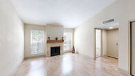 Located at 10751 Meadowglen Ln in Houston, TX, this single-story, 2-bedroom, 4-bathroom home offers a well-organized and functional layout. The living room serves as the heart of the home, featuring light hardwood-style flooring, large windows that invite natural light, and a standout stone-surround fireplace with a warm wood mantle — an elegant focal point for the space.

The galley-style kitchen is efficiently designed with granite countertops, white cabinetry, hardwood-style flooring, and a full suite of black appliances including a gas range, microwave, dishwasher, and refrigerator. A window at the far end of the kitchen adds brightness to the space.

Both bedrooms are carpeted and include ceiling fans with light fixtures. Each room benefits from natural light through windowed blinds, and the primary bedroom offers a comfortable, private retreat with its own closet access. Two additional closets provide ample storage throughout the unit.

The four bathrooms include tiled shower-tub combos and hardwood-style flooring, maintaining a clean, consistent aesthetic. Neutral tones and light walls are carried throughout the home, creating a cohesive and calm ambiance. This thoughtfully designed home combines practicality with comfortable living in a convenient Houston location.