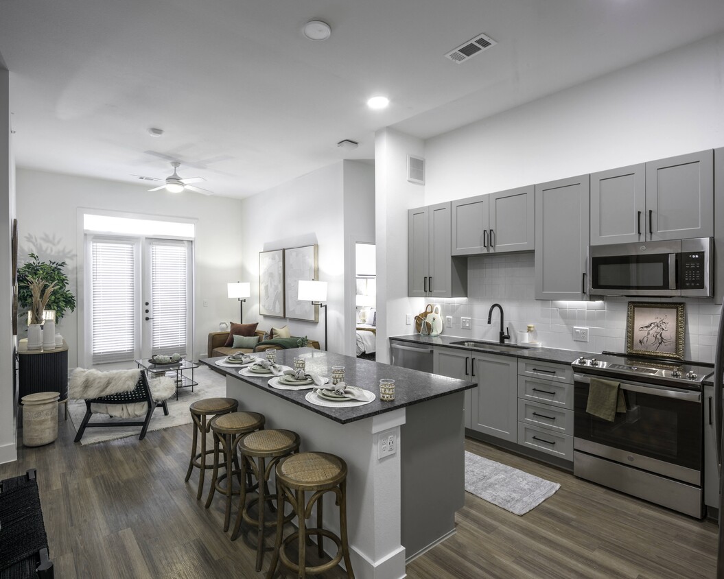 Upgrade your culinary space with stunning granite countertops and a spacious kitchen island, perfect for both style and functionality. - Modera Walsh