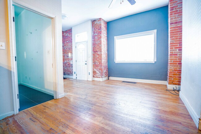 Entertain in the living area with gorgeous hardwood flooring! - 2944 Welton St