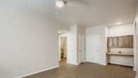 This 860 square foot apartment in Dallas, TX offers a well-designed living space with 2 bedrooms and 3 bathrooms. The single-story layout maximizes efficiency, with the primary bedroom measuring 150 square feet. The open-concept kitchen and living room create a spacious feel, featuring light wood cabinetry, white appliances, and a breakfast bar. The kitchen is equipped with ample storage and counter space.

Throughout the apartment, warm wood-look flooring adds a touch of elegance and continuity. Large windows in the bedrooms and living areas provide natural light, enhancing the airy atmosphere. The bathrooms are modern and functional, with one featuring a tub-shower combination with accessibility grab bars.

The property includes a dedicated laundry area and a closet for additional storage. The neutral color palette of white walls and light wood tones creates a blank canvas for personalization. Ceiling fans and recessed lighting contribute to the overall comfort and ambiance of the space.

This apartment combines practicality with modern design, offering a comfortable living environment in a compact yet well-utilized floor plan. Its location in Dallas provides urban convenience in a residential setting.