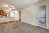 Located at 975 Woodland Parkway in San Marcos, CA, this two-bedroom, one-bathroom residence offers a practical and comfortable single-floor layout. The kitchen is efficiently designed with warm honey-toned cabinetry, light marble-style countertops, and a full suite of stainless steel appliances including a French door refrigerator, electric range, built-in microwave, and dishwasher. Light wood-look flooring runs through the kitchen and entry, creating a clean transition into the carpeted living room, which features a ceiling fan and a window that draws in natural light and greenery views. Both bedrooms are carpeted and well-lit by natural light through sliding-blind windows. The primary bedroom includes a closet and direct access to a private balcony overlooking lush surroundings, while the second bedroom offers a reach-in closet and easy access to the kitchen area. The bathroom is finished with light wood-look flooring and includes a full tub-shower combination with grab bars, an over-toilet storage unit, and clean white fixtures. This residence provides a functional and comfortable living environment in a serene San Marcos setting.