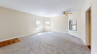 Located at 1521 S Third St in Louisville, KY, this two-bedroom, one-bathroom unit offers a practical and comfortable single-floor layout. The spacious living room greets you at the entry, featuring soft carpet, neutral cream-toned walls, a ceiling fan with light fixture, and multiple windows that allow ample natural light to fill the room. A hallway connects the main living areas to the private quarters.

The kitchen stands out with warm hardwood flooring, white shaker-style cabinetry, granite-look countertops, a double stainless steel sink, a dishwasher, and an electric range — all complemented by a window overlooking greenery outside.

The generously sized primary bedroom features plush carpet, a ceiling fan, and two windows offering pleasant outdoor views. It also includes two closets, providing excellent storage. The second bedroom is cozy and well-lit with a window and carpeted flooring, making it versatile for various uses.

The full bathroom is clean and functional, featuring tile flooring, a shower/tub combo, and a louvered linen closet for added storage.

Throughout the unit, warm beige walls, consistent carpeting, and ceiling fans create a cohesive and comfortable atmosphere suited for everyday living.