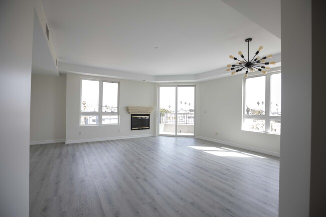 Living room with balcony and fireplace - 12222 Wilshire Blvd