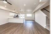 Located at 210 N Fourth St in West Branch, Iowa, this three-bedroom, three-bathroom home spans three floors with a well-organized and functional layout. The ground level includes an attached garage with an automatic opener and concrete flooring, offering convenient and secure parking. The main level is home to a bright, open-concept kitchen and living area finished with warm wood-look flooring throughout. The kitchen is equipped with white shaker-style cabinetry, a central island with a light countertop, stainless steel appliances including a gas range, microwave, and French door refrigerator, and pendant lighting. The living area connects seamlessly to the kitchen and features a ceiling fan, recessed lighting, and windows that invite natural light and outdoor views. A staircase connects the main level to the upper floor, which houses all three bedrooms, including a generously sized primary bedroom with a walk-in closet featuring wire shelving. Additional bedrooms offer built-in closets and large windows with views of the surrounding neighborhood. The three bathrooms include tub/shower combinations with clean white surrounds. Neutral tones, wood-look flooring, and modern fixtures create a consistent, contemporary aesthetic throughout the home.