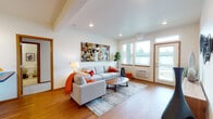 Located at 16609 East Desmont Court in Spokane Valley, WA, this single-floor unit offers a well-organized layout with consistent, warm design details throughout. The living room serves as the heart of the space, featuring wood-look flooring, recessed lighting, and a tray ceiling that adds architectural interest. Large windows and a glass-paneled entry door flood the area with natural light and provide views of the surrounding greenery, creating an inviting and open atmosphere.

The galley-style kitchen is efficiently designed with warm wood cabinetry, dark countertops, a tile backsplash, and stainless steel appliances including a full-size refrigerator and range. Wood-look flooring continues through this space, maintaining a cohesive look.

Two well-proportioned bedrooms offer plush carpeting, large windows with natural light, and baseboard heating. Each room provides a comfortable and restful environment. The unit includes two bathrooms: one featuring a single-sink vanity with wood cabinetry and tile flooring, and a second with a tub/shower combination, wood-look flooring, and matching cabinetry. Warm wood-toned door and trim details are consistent throughout, tying the entire space together with a clean, functional aesthetic.