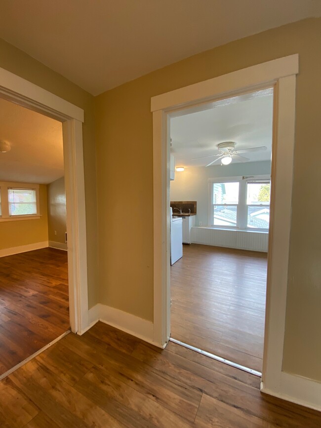 View from the landing into the kitchen and smaller bedroom - 3735 Fawcett Ave