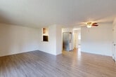 Located at 4428 212th St SW in Mountlake Terrace, WA, this 2-bedroom, 1-bathroom unit offers a well-organized single-floor layout designed for comfortable everyday living. The open living and dining area is finished with light-toned laminate hardwood flooring and features a ceiling fan, textured ceilings, and a sliding glass door that leads to a private balcony with outdoor views of surrounding greenery. The kitchen is appointed with rich wood cabinetry, granite-style countertops, stainless steel appliances including an electric range, microwave, and refrigerator, and continues the light hardwood flooring for a cohesive look. Both bedrooms are carpeted and bright, each featuring large windows with views of lush foliage and generous closet space with bi-fold doors. The primary bedroom offers a comfortable footprint with ample room for furnishings. The full bathroom includes a rich wood vanity with a granite-style countertop, a tub/shower combo, and hardwood-style flooring. Additional conveniences include an in-unit laundry area, a hallway connecting the main spaces, and four closets distributed throughout for exceptional storage. The overall ambiance is clean, bright, and move-in ready.